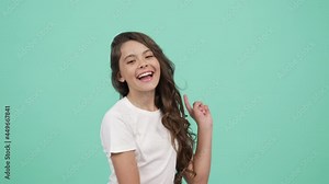 moving child with happy face dancing and directing fingers different sides point finger on camera
