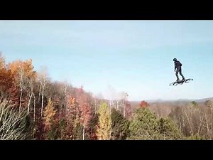 Human drone above the mountain trees