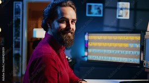 Portrait of smiling photographer using photo editing software on PC display in multimedia creative studio. Happy freelancer using photographs retouching program, zoom in shot