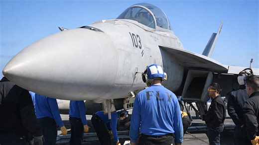 US Navy sailors at work on aircraft carrier