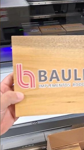 Engraving the client's logo on the solid wood case using UV printing.