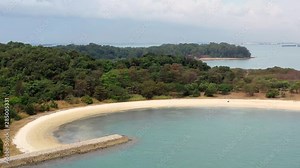 Aerial, tracking, drone shot, of the Lazarus island beach, on a sunny day, at the Singapore strait, Asia