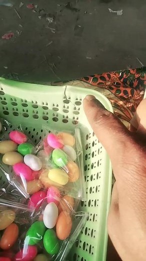 Exploring Colorful Jelly Beans in a Green Basket