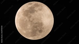 Moon with clouds being blown by winds during storm at nights