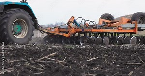 Slow motion Tractor Plowing Field Tillage Agricultural land Farm Agriculture Preparing the soil for sowing. Plow Machine Equipment Working Rural Season