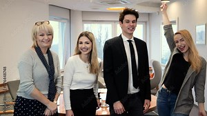 A team from different generations stands representatively in an elegant office
