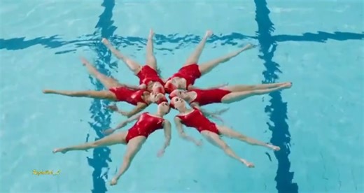 A group of girls performs an artistic show in the swimming pool with Rai music