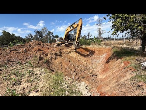 The groom hired an excavator to dig a hole in the pond where he plans to build a pig pen.