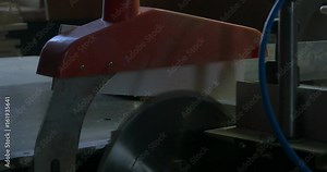 Man at work sawing wood. Circular saw. A machine which saws wood, particle Board and fiberboard. Industrial production of furniture.