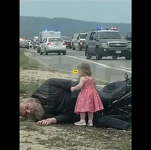 The little girl in a princess dress refused to let go of the injured biker even the police couldn’t pull her away. They found him unconscious in a ditch off Route 27, his motorcycle wrecked twenty feet away. And there she was a tiny girl, no older than five singing “Twinkle, Twinkle, Little Star” while pressing her hands against the gash in his chest like she’d been trained. Except no one had ever taught her. “Don’t take him!” she screamed when paramedics arrived. “He’s not ready! His brothers a