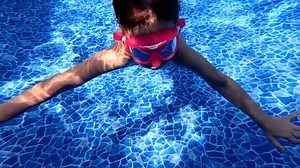 clip-3575132831-little-girl-jumps-swims-underwater-pool