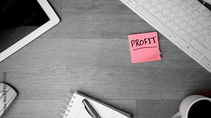 Pink post its with profit written in bold falling on office desk Stock Video