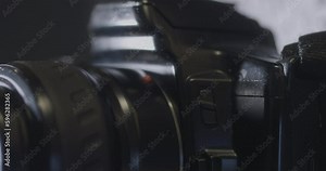 Hand removing and Attaching lens on an unrecognizable camera, Close-up shot