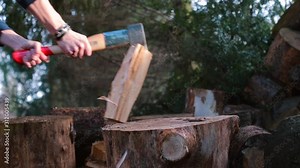 Close-up of chopping wood logs with an ax.