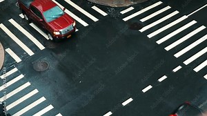 Three different cars one by one cross intersection under the rain at daytime. Wet asphalt on the street with crosswalks. Black Suv, red pickup and silver sedan. Slow motion.