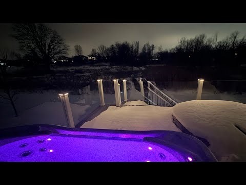 Enjoying Warm Hot Tub Soak in Winter Snowy Landscape with Spa Infinity Edge Hotizon Tub