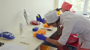 Blood test and microscope using in laboratory.