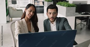 Sales manager showing presentation, showcase benefits of services offering to client at formal meeting in modern office. Female mentor helps with online task, software or corporate program to teammate