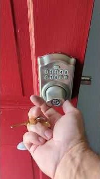 Operating the override key with a Schlage BE365 push button deadbolt.