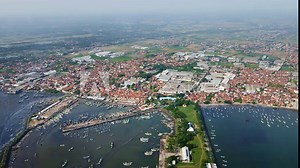 Muncar Fishing Port, Banyuwangi, East Java, the largest fishing port faces dense living conditions and struggles with air and water pollution from nearby fish factories, as captured by drone footage.