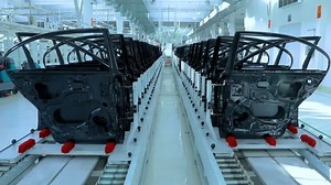 Real shot automobile plant, modern production of cars, transportation of ready car doors on the manufacture line, robots at work | Premium Stock Video Footage