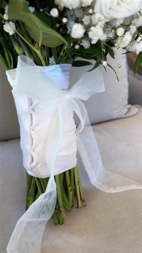 Have you given any thought to what will be wrapped around your flowers on your wedding day? Most florists finish bouquets with a ribbon of choice, but a custom bouquet wrap gives you the opportunity to add something far more meaningful. Our signature adjustable bouquet wraps are a beautiful way to incorporate mom’s wedding dress into your big day. They are a subtle nod to family without competing with your overall wedding look. Or we can create one from the alteration scraps of your own gown to 