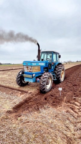 Ford TW-35 tractor in action ploughing