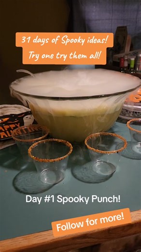 Halloween Punch made with orange sherbet and 7UP is an easy party drink everyone will love. This spooky drink can be decorated with plastic eyeballs on top and some dry ice! Cups are dipped in festive Sprinkles! #halloween #spookydrinks #dryice #sherbet #7up #spooky #spookyseason #spookytreats