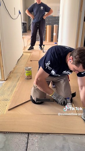 Installing the border that frames the entire hallway design. #craftsmanship #fyp #flooring #hardwoodflooring #woodflooring