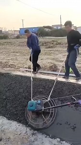 Two workers are using a power trowel to smooth and finish freshly poured concrete #ConcreteFinishing #PowerTrowel #ConstructionWork #SmoothConcrete #TeamEffort | Metzgerei Ogunquit Studio | Facebook