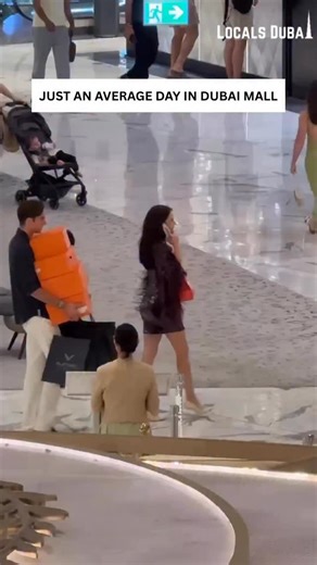 🛍️ A look at Just an average day in Dubai Mall! Witnessing the spectacle of luxury shopping and style in one of the world’s most iconic retail destinations. From the gentleman juggling a massive stack of Hermès orange boxes and multiple shopping bags, likely from high-end luxury brands, to the impeccably dressed woman chatting on her phone, this snapshot captures the glamorous and extravagant atmosphere that defines Dubai Mall’s shopping experience. Every corner of this mall is a testament to g