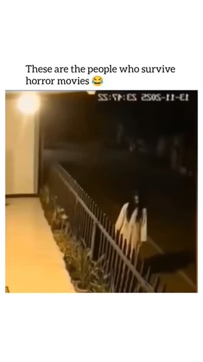 Laugh Vault on Instagram: "This video is a short, humorous clip captured by a night-vision security camera that plays on the cliché reactions of characters in horror movies. The scene takes place outside a house at night. A person dressed in a white gown with long black hair, resembling a ghost or a character from a popular horror movie like The Ring or The Grudge (often referred to as a Pontianak or Kuntilanak in Southeast Asian folklore), is seen standing motionless outside the railing. Sudden
