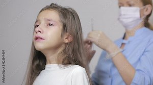 little girl is afraid of the doctor with a syringe. baby cries afraid injection Stock Video