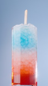 What was your go-to popsicle as a kid? 🤔 🍦 Share this Firecracker Soda with your childhood bestie 🤗 🧨 🥤 Recipe 👇 - 2/3 cup sparkling water (divided) - 2 Tbsp Torani Cherry Syrup - 1/2 Tbsp Torani Blue Raspberry Syrup - Ice - 1/3 cup of lemonade - Woodcraft stir stick Combine 1/3 cup sparkling water with Torani Cherry Syrup. Next, combine 1/3 cup sparkling water with Torani Blue Raspberry Syrup. Add ice to a glass and add Cherry sparkling water. Add more ice, and pour in lemonade. Add anoth