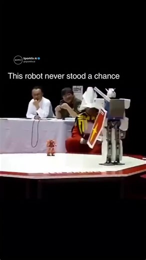 @sparklix.ai on Instagram: "This was supposed to be a robot sumo match, but the size difference made the outcome obvious almost instantly. A massive Gundam-style robot stepped into the ring against a tiny opponent, and the fight was basically over before it even began. The smaller robot barely had time to react before getting knocked out, turning what should have been a competition into a one-sided mismatch. The referee couldn’t stop laughing, the crowd lost it, and the whole moment felt more li