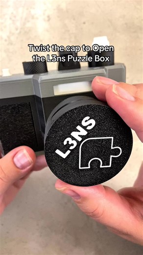 Twist the cap to help open up the L3ns Camera Puzzle Box. #puzzlebox #puzzlesolving #puzzlesolved #puzzle #puzzlemaster | Puzzle Master Inc.