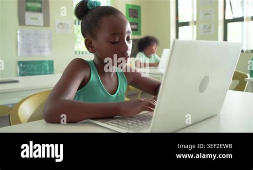 Classmates with African American girl typing on laptop in classroom after task, pausing, smiling. Student, school, computer, technology, focus, concentration, bright Stock Video Footage - Alamy