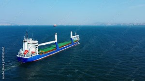 Bulk carrier or bulker is a merchant ship transport unpackaged bulk cargo, grains, ore, coal. Aerial wide shot