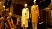 Elegant female mannequins near stairs in a fashion shop showcase
