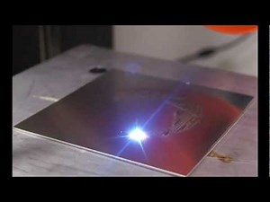 Fiber Laser Scores Aperture Logo in Steel While Playing Portal's Still Alive Theme Song