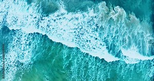 Beautiful sea summer landscape, Waves sea water surface High quality video Bird's eye view, Drone top view waves crashing on sand beach,Nature ocean sea beach background