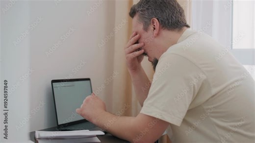 Stressed overwhelmed man experiencing work burnout at home office