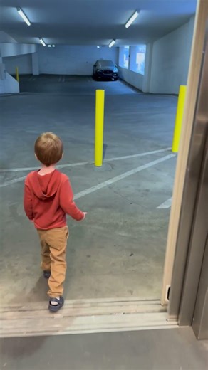 Preschooler rides elevator at Capitol Garage.