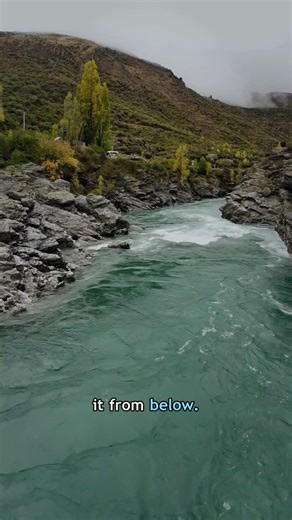 A river still sliding through dry country, like the ground is secretly pouring it from