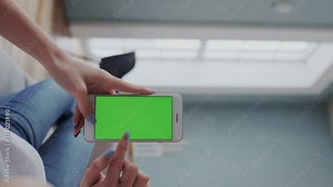 Vertical video in POV. Hands with Green Screen. Colour Chroma Key, Touch Screen Display for Mapping Ad or Content. Click or Tap in Different Parts of the Screen with finger, Using New Innovative Apps.