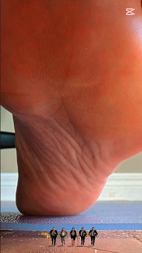 something big is getting even bigger. huge feet, tiny people