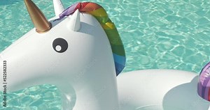 Close-up Inflatable Circle Unicorn Floats in Outdoor Infinity Swimming Pool on Sunny Day Luxury Hotel Resort. Summer Holidays, Travel Vacation. High quality 4k footage Stock Video
