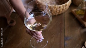 Sommelier meticulously examines white wine in wineglass Breathtaking view of wine swirling in wineglass Immerse yourself in finesse of wine tasting Experience elegance wine through lens of wineglass