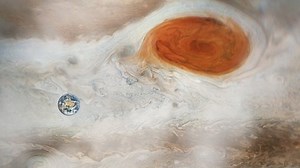 Planet Earth orbiting the Great Red Spot in Jupiter. Elements of this video furnished by NASA.
