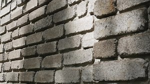 Texture of a stone wall.Leaves shadow on the wall.brick wall for texture background.